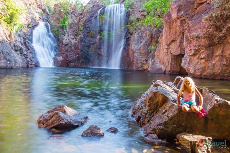 girl sitting on rock in front of Florence Falls, 