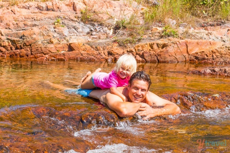 people laying in a river