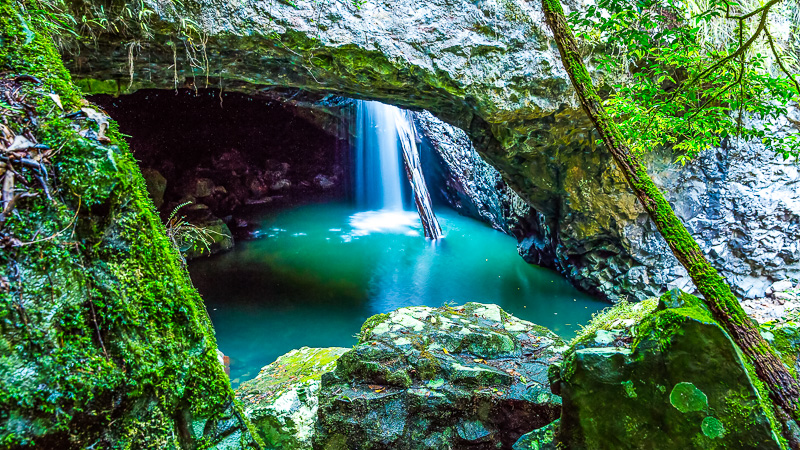 waterfall coming through cave roof