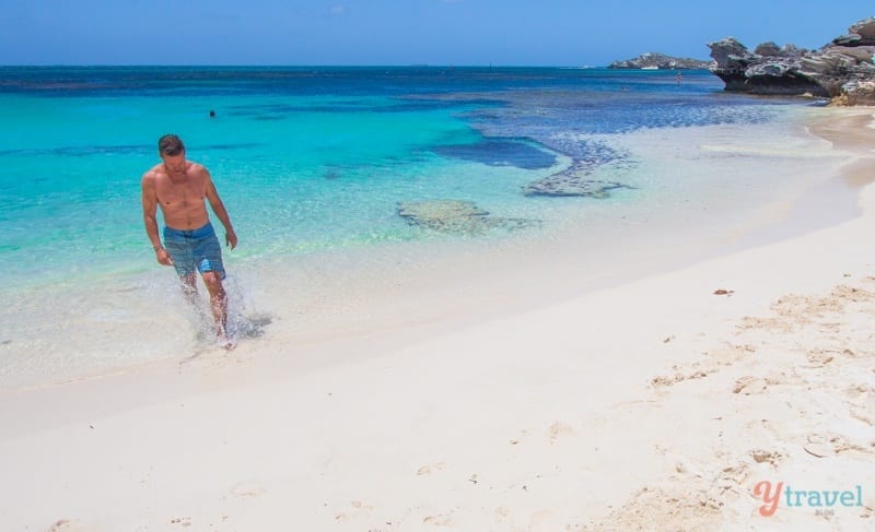 man walking into the ocean