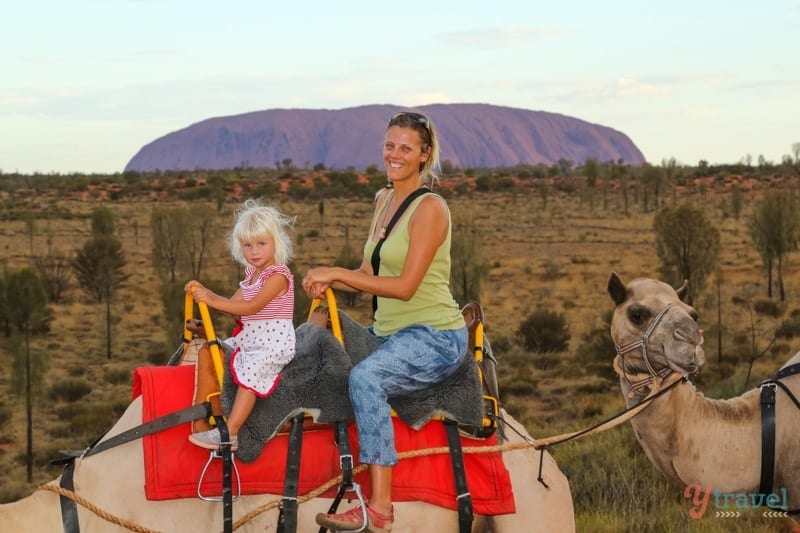 people sitting on camels