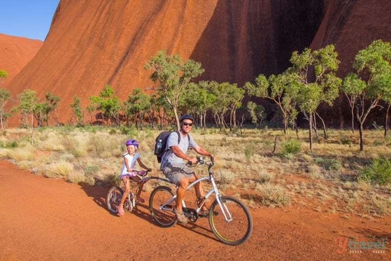 man and child on tag a long bike