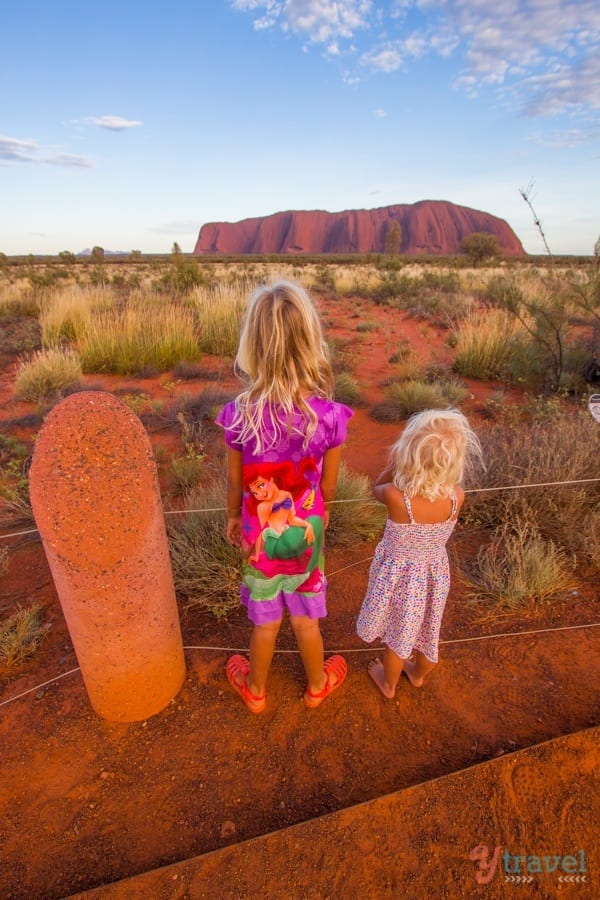 young girls looking at uluru