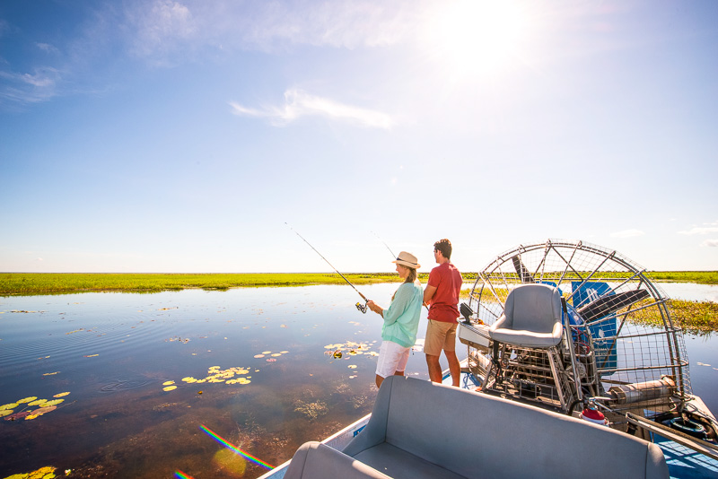 people fishing off a boat at Wetlands Airboat Safari, Mary River National Park, NT