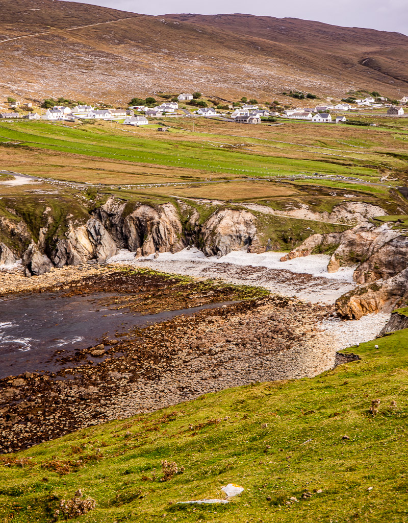 A bay inlet of rocks, sand and water