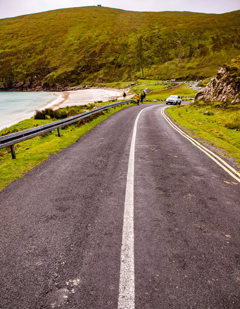 A coastal road sloping down towards a beach