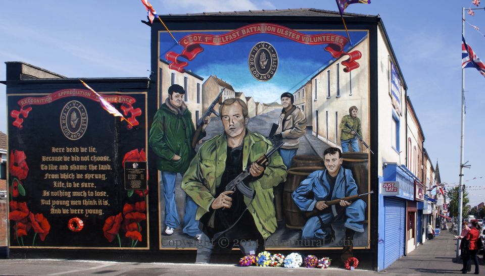 Mural of men holding guns in Belfast, Ireland