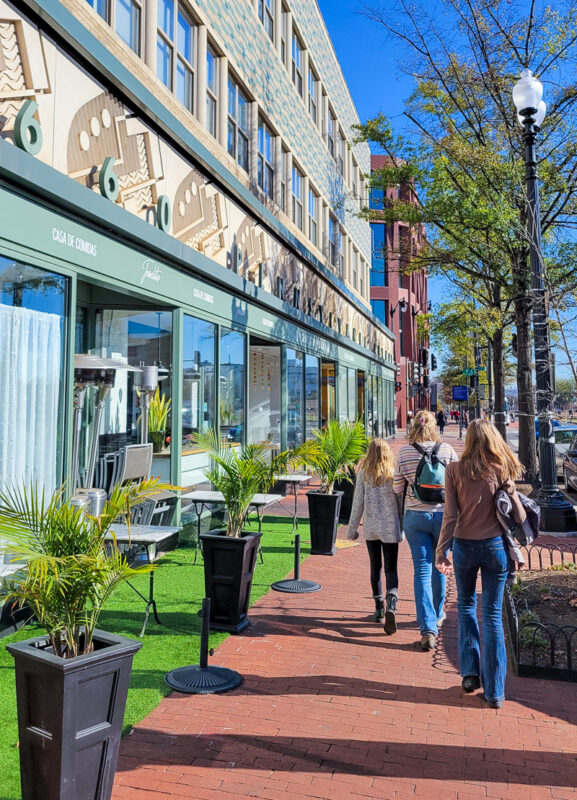 Family walking on a sidewalk in main street Capitol Hill