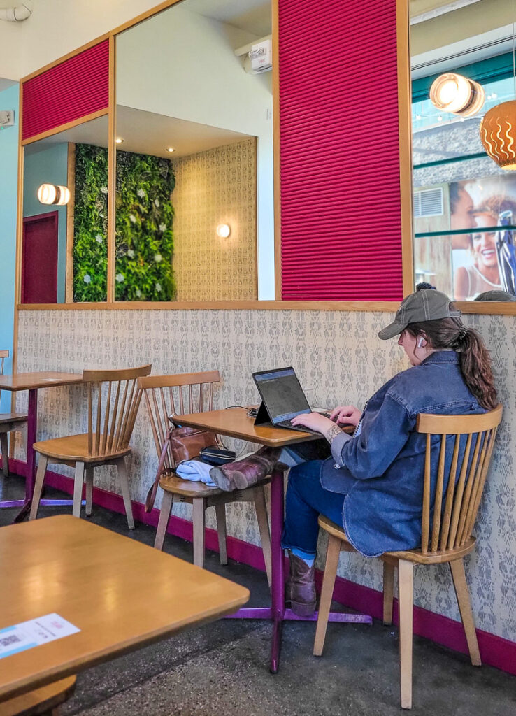 Person sitting at a table in a coffee shop