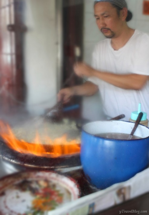 man cooking oyster omelettes Chinatown Bangkok