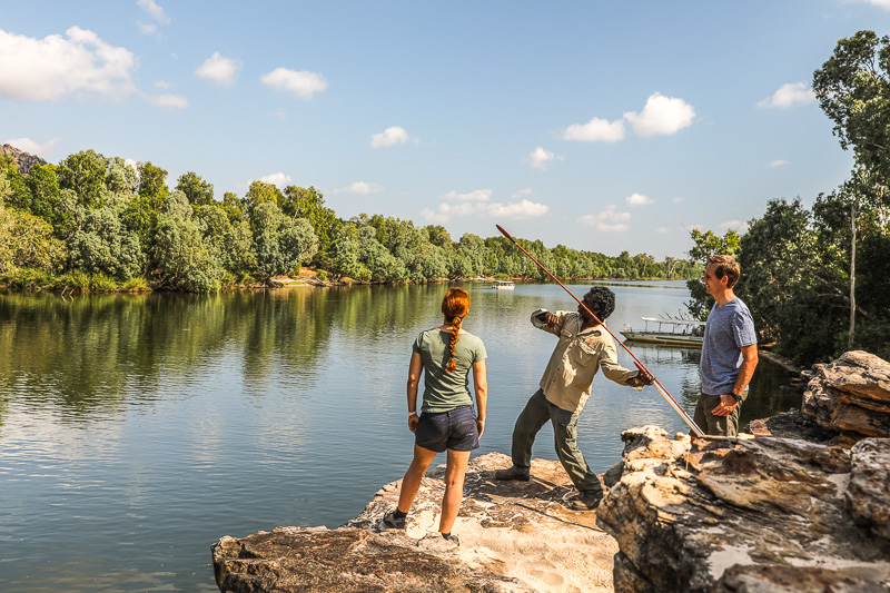 Visitors with an Aboriginal guide demonstrating spear throwing during a Guluyambi Cultural Cruise on the East Alligator River.