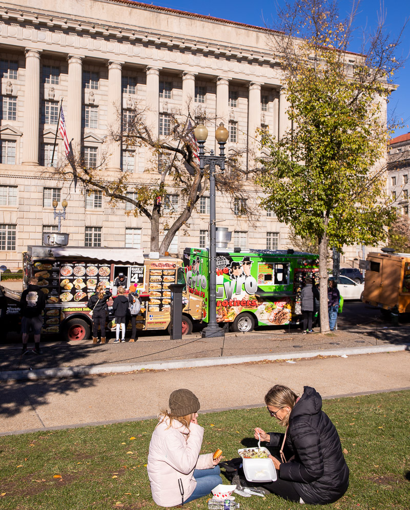 Mom and daughter eating food from a food truck