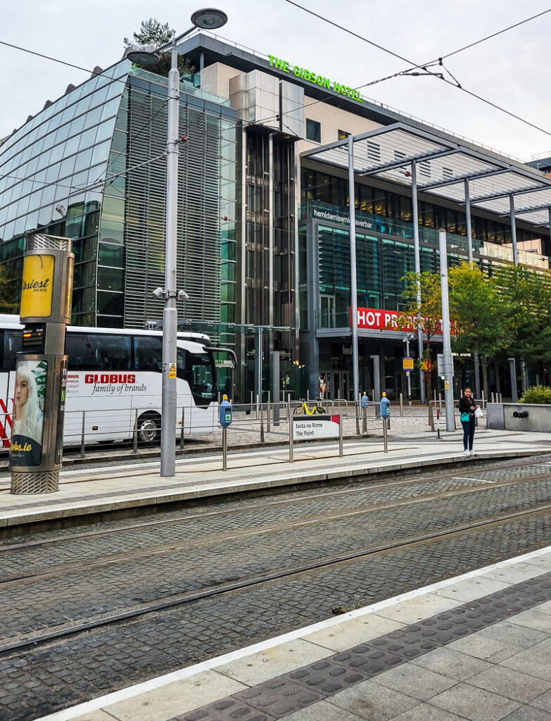 A bus parked out the front of a hotel