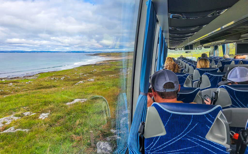 People looking out a window on a bus