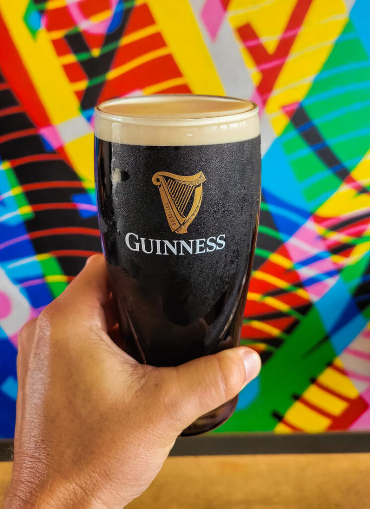 Hand holding a glass of Guinness beer