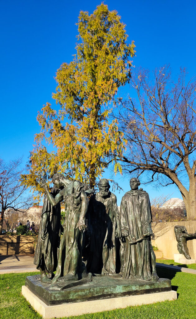 4 figures standing ina  group The Burghers of Calais