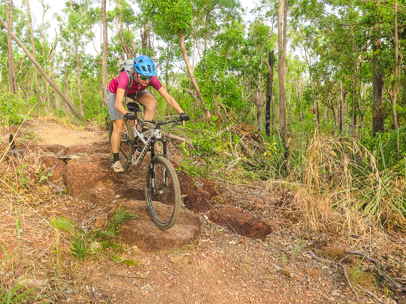 A visitor mountain biking in Charles Darwin National Park.