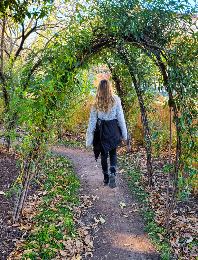 Girl walking through a garden