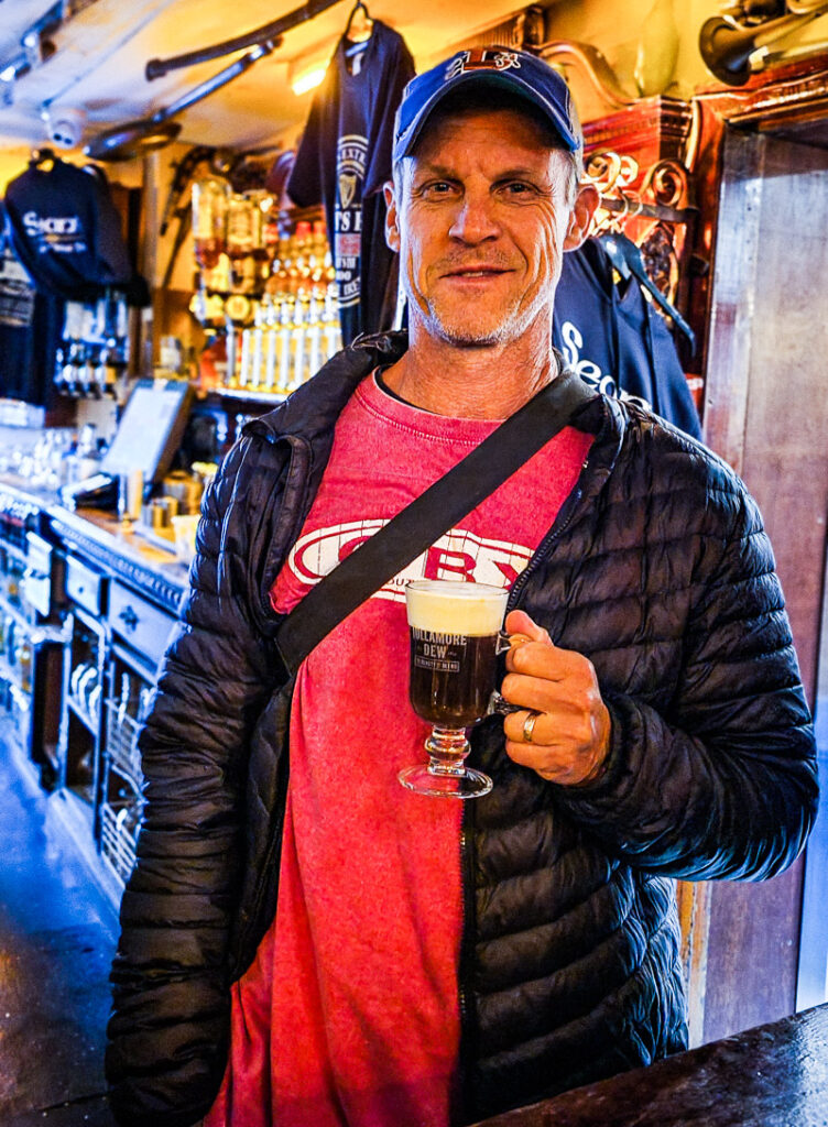 Man standing up with a coffee in hand