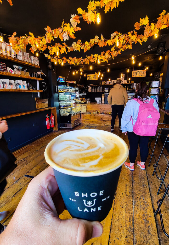 Cup of coffee and people in a cafe