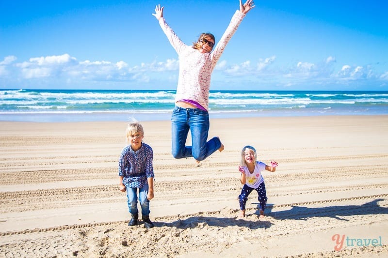 people jumping in the air on the beach