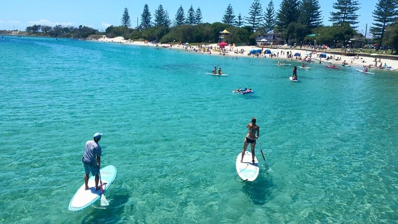 people paddle boarding on Tallebudgera Creek