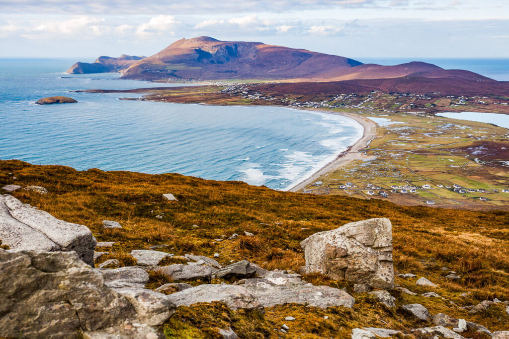 Aerial view of a bay and beautiful beach with a rocky headland