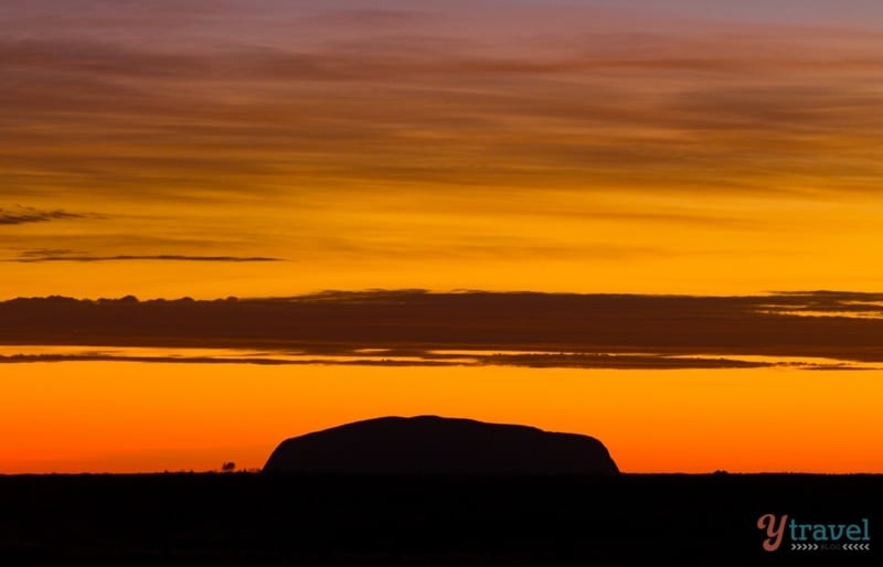 silhouette of Uluru iwith orange sky