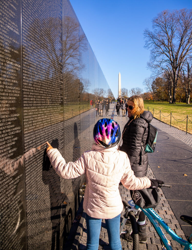 Mom and daughter looking at a memorial in DC