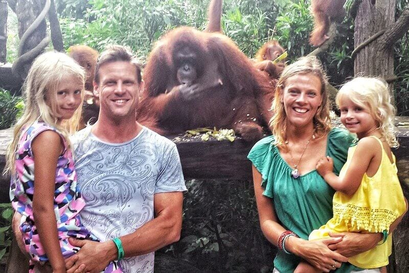 family posing with Orangutans at Singapore Zoo 