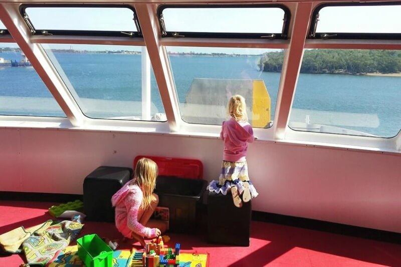 girl looking out window On the ferry to Moreton Island, Queensland