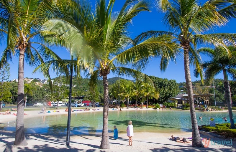 girl standing on sand at The Lagoon at Airlie Beach