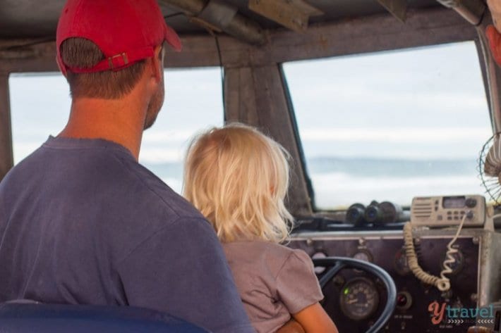 little girl driving a boat