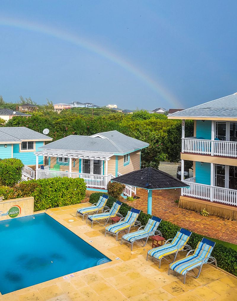 Rainbow in the sky over a pool at a resort