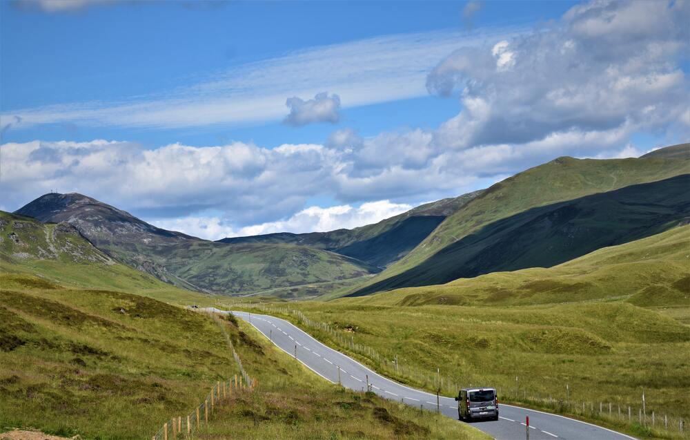 car driving on the road through the Cairngorms National Park