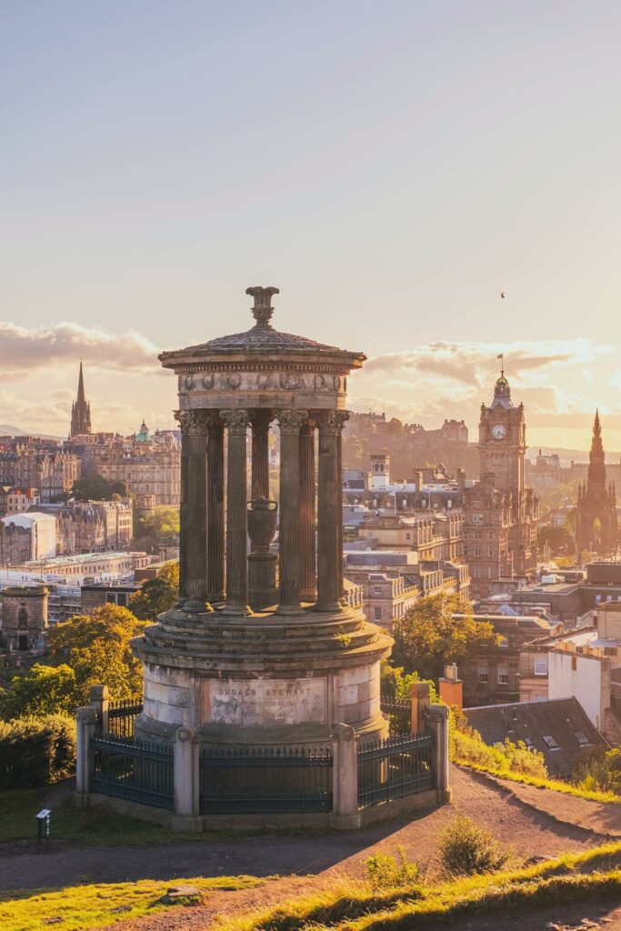 tall stone memorial with backgroundof edinburgh