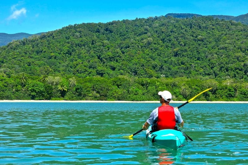 man kayaking on ocean