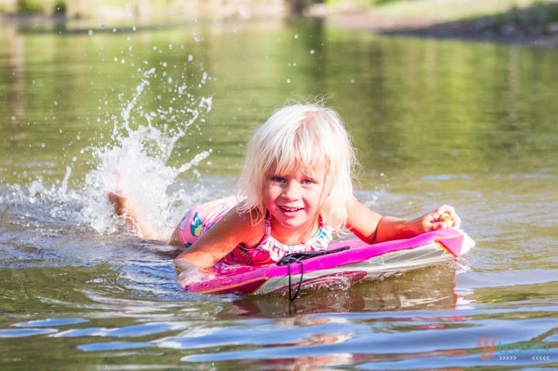 a girl laying on a floatie in a river