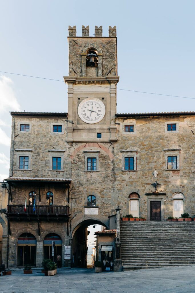 Stairs leading up to building with clock tower