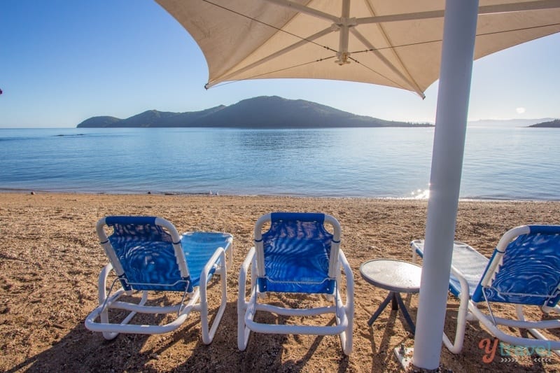 beach chairs and an umbrella on the beach