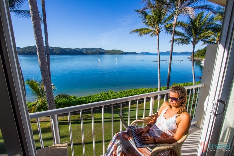 woman reading on a balcony