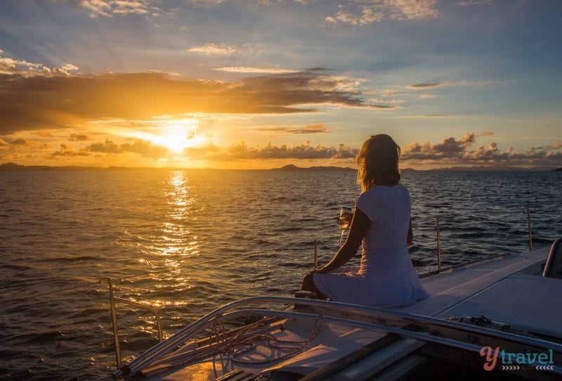 woman watching sunset on boat