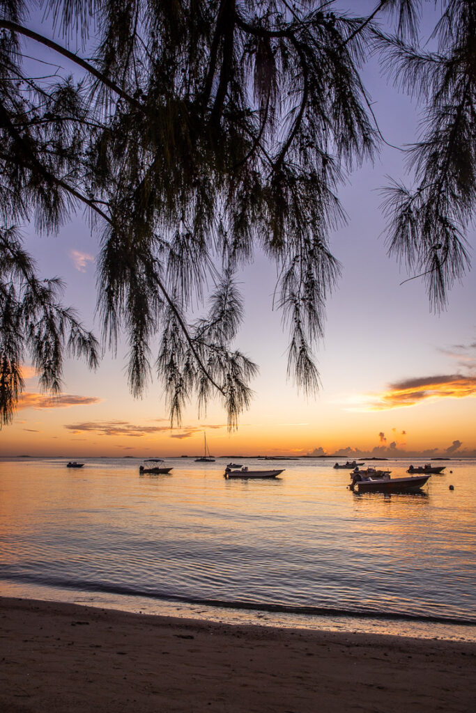 Sunset with boats moored near the beach