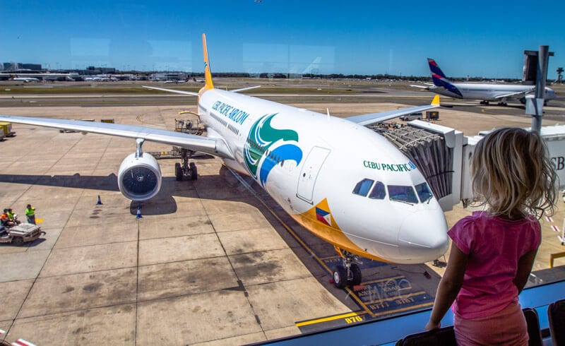 girl looking at plane in an airport