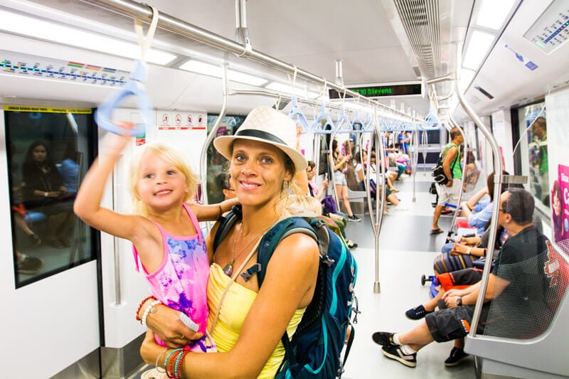 woman holding a child on a train