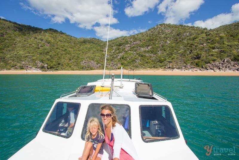 woman and girl sitting on front of boat 