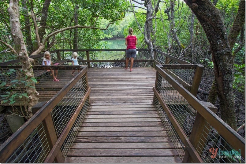 woman standing on a board walk