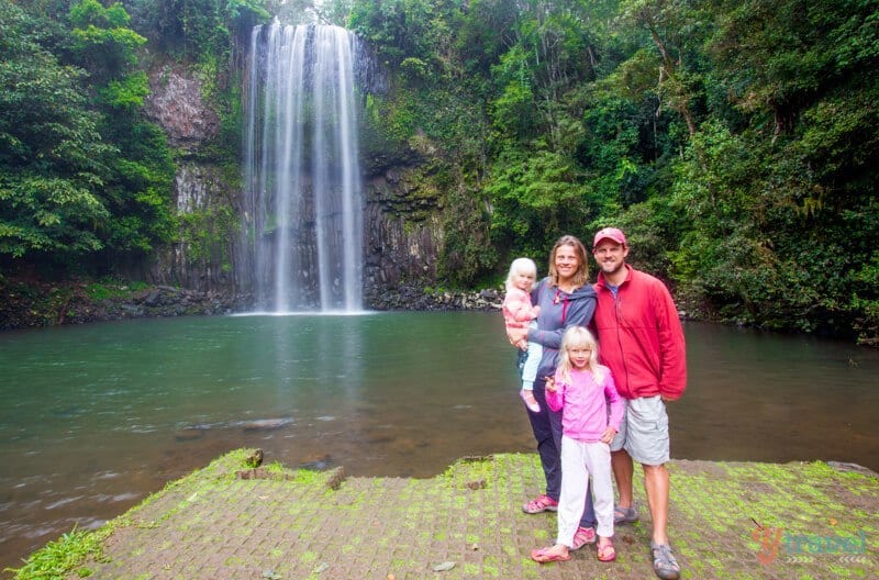 family posing in front of Millaa Millaa Falls, Queensland, Australia