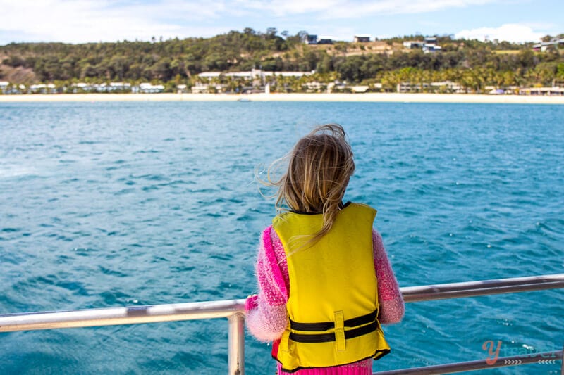 girl wearing a life jacket on a boat