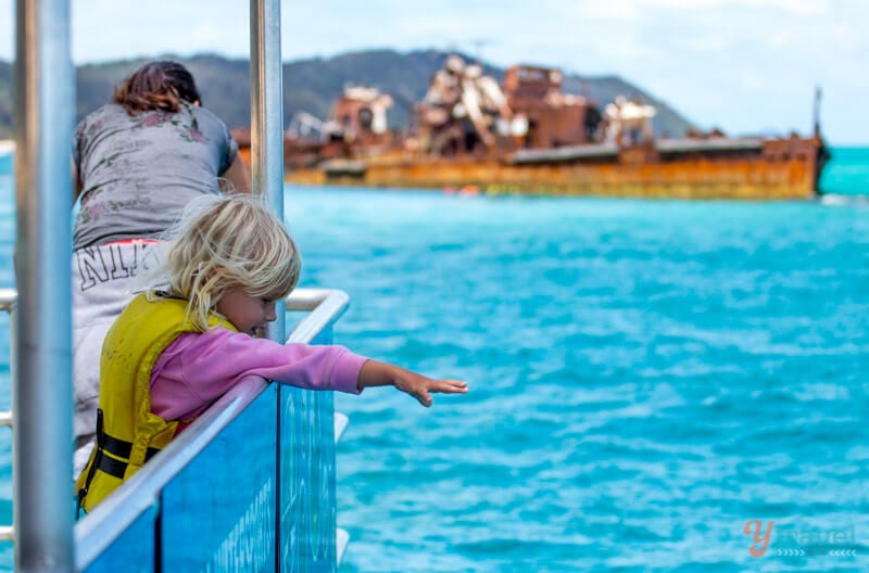 girl on a boat looking at the water